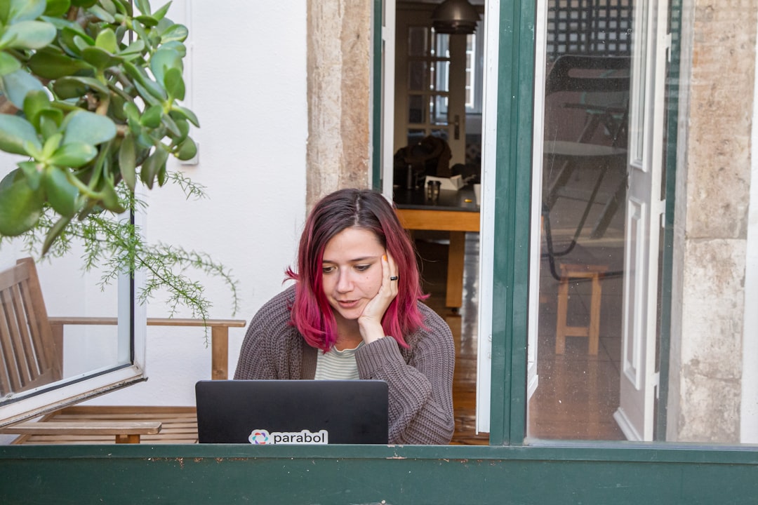 growth digital nomad culture — growth digital nomad culture — person working on laptop in a sun-lit Lisbon café with tiled walls and espresso on the table