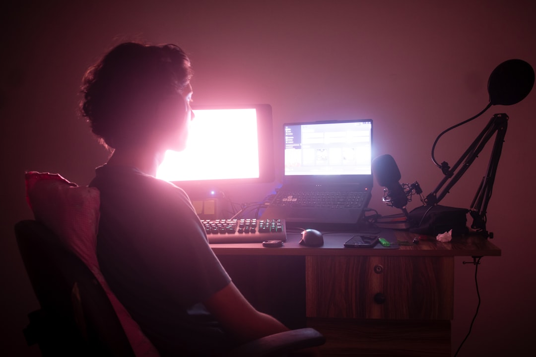 generative ai software development — generative ai software development — developer using AI coding assistant on a dual-monitor desk setup