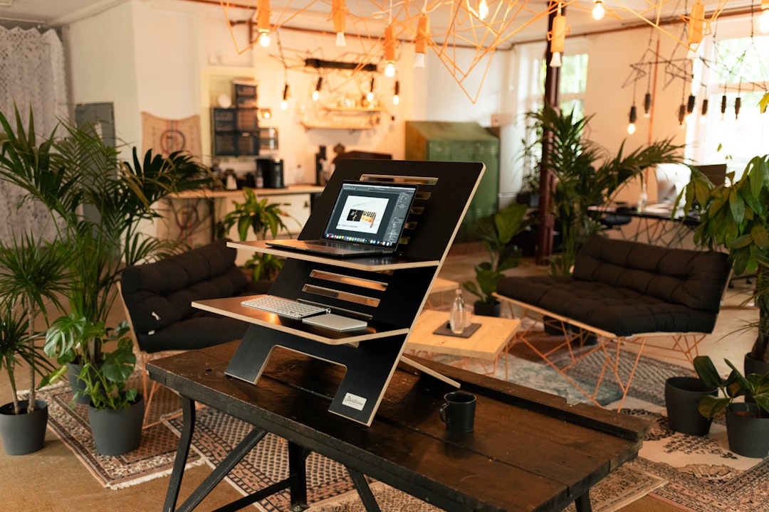 rise wellness-focused living among — rise wellness-focused living among young professionals in a modern co-working space, surrounded by plants, a yoga mat in the corner, and a wellness app open on a laptop