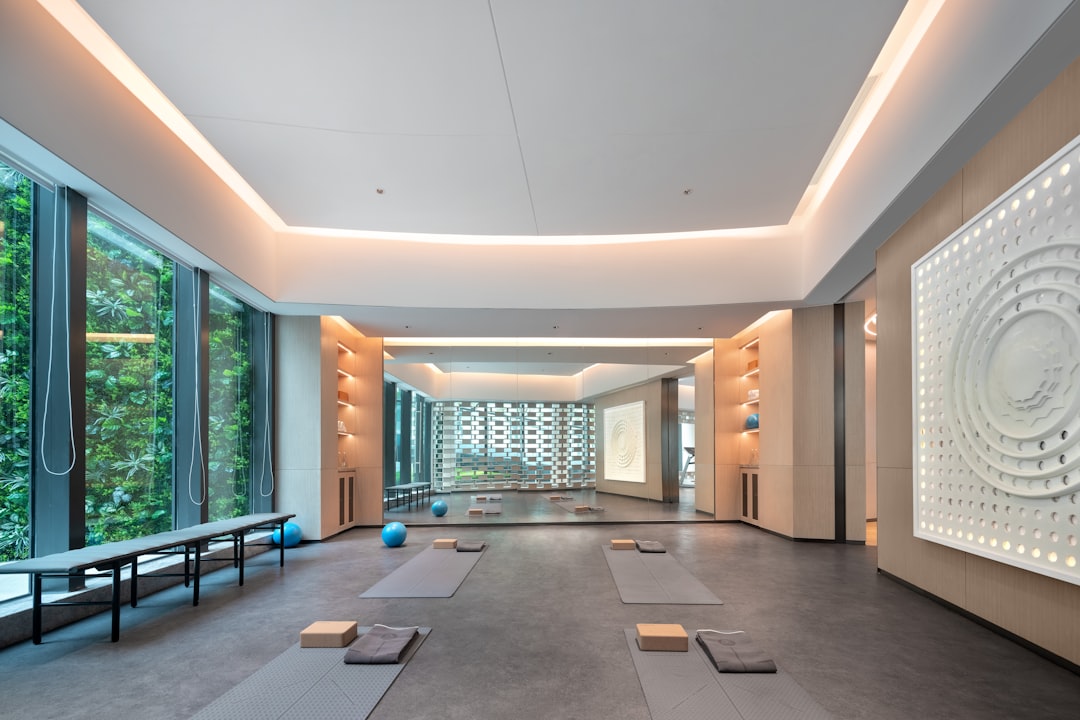 rise wellness-focused living among — rise wellness-focused living among young professionals — a group fitness class in a modern corporate wellness space with natural lighting and wood-paneled interiors
