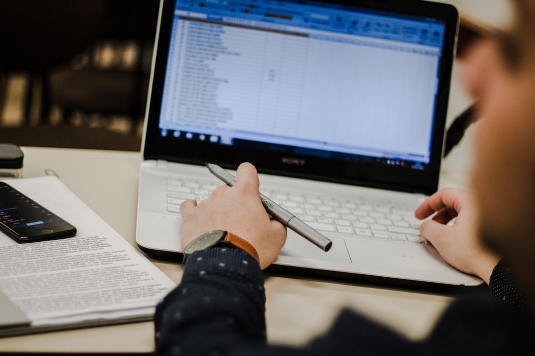 skills students need succeed — student writing notes alongside a laptop with data charts on screen
