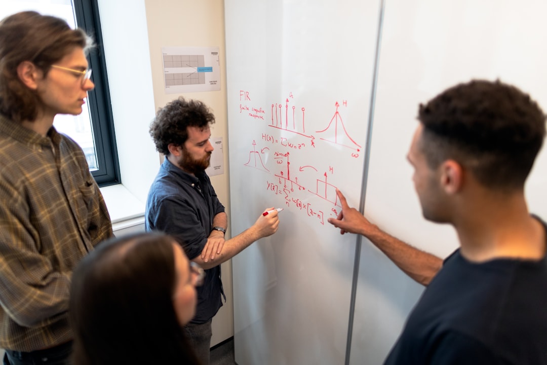 skills students need succeed — diverse team collaborating around a whiteboard in a modern office space