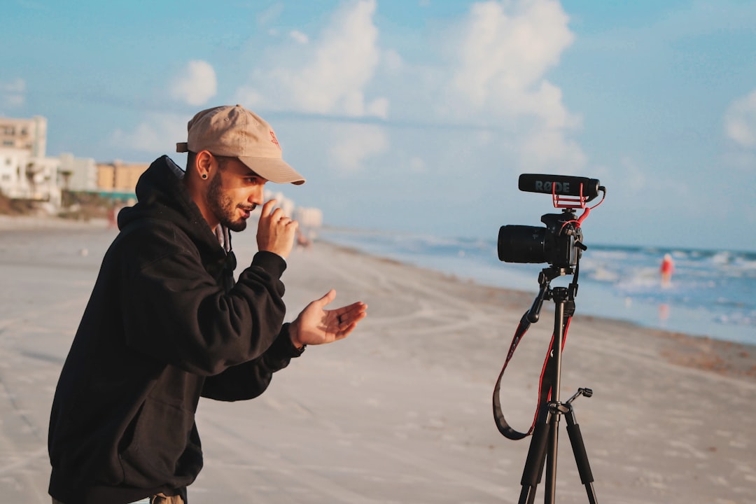 role storytelling building powerful — a content creator filming a short-form brand video on a smartphone against a natural outdoor background