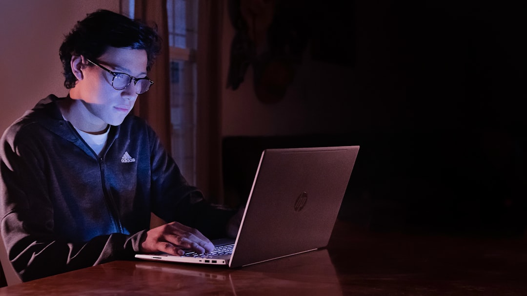 ai classroom learning across the globe — student using AI tutor on a laptop at night with bright screen