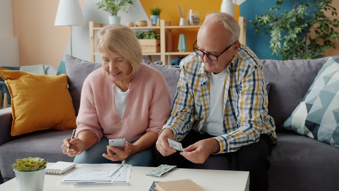 future personal wealth management — wealth advisor and client reviewing portfolio on tablet device