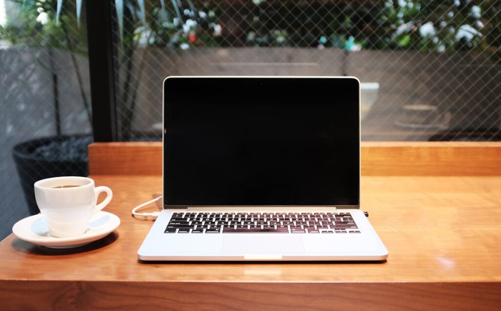 growing popularity hybrid living — laptop coffee cup travel nomad
