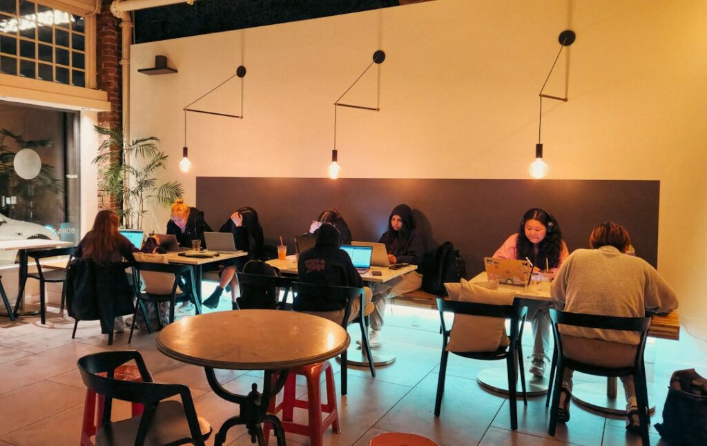 rise digital nomad communities — laptop cafe coworking space vibrant
