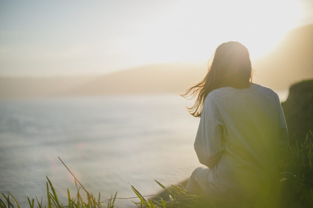 growing popularity wellness tourism — woman meditating peaceful spa retreat
