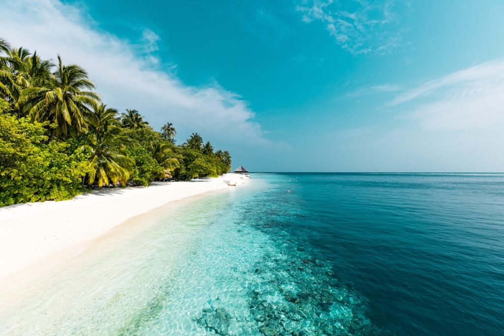rise remote island tourism — secluded tropical island turquoise waters