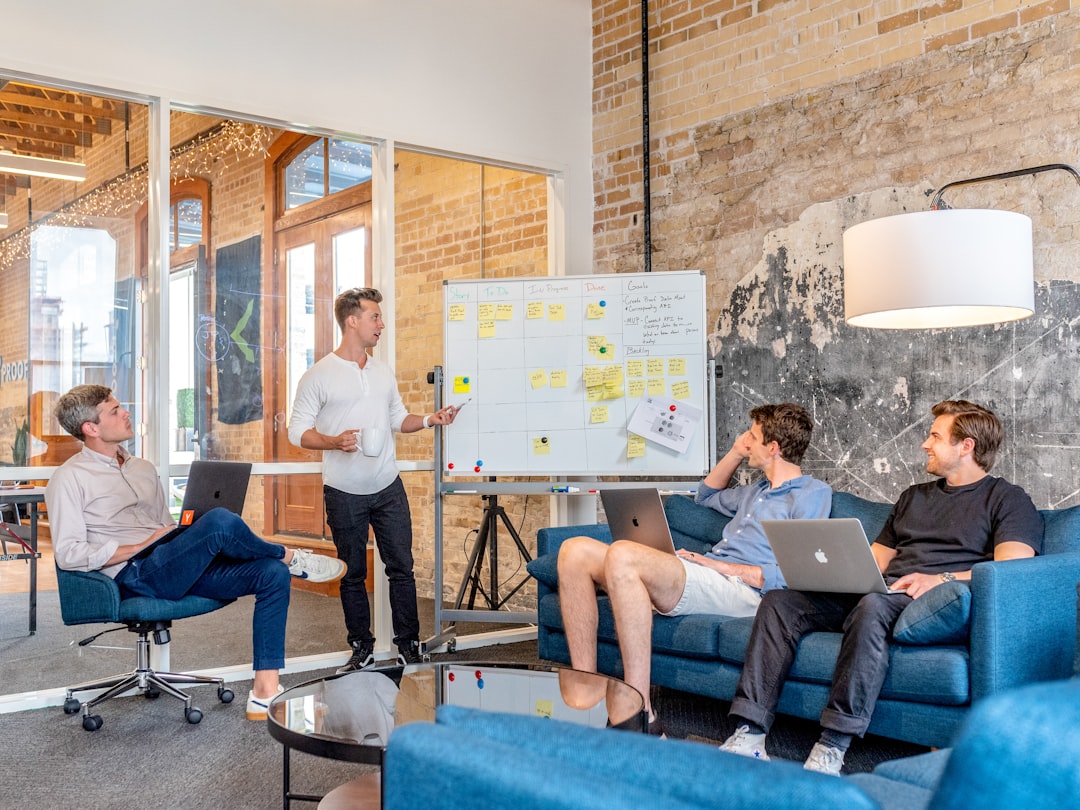 rise skill-based hiring means — diverse group of professionals collaborating in modern office meeting room with skills written on whiteboard