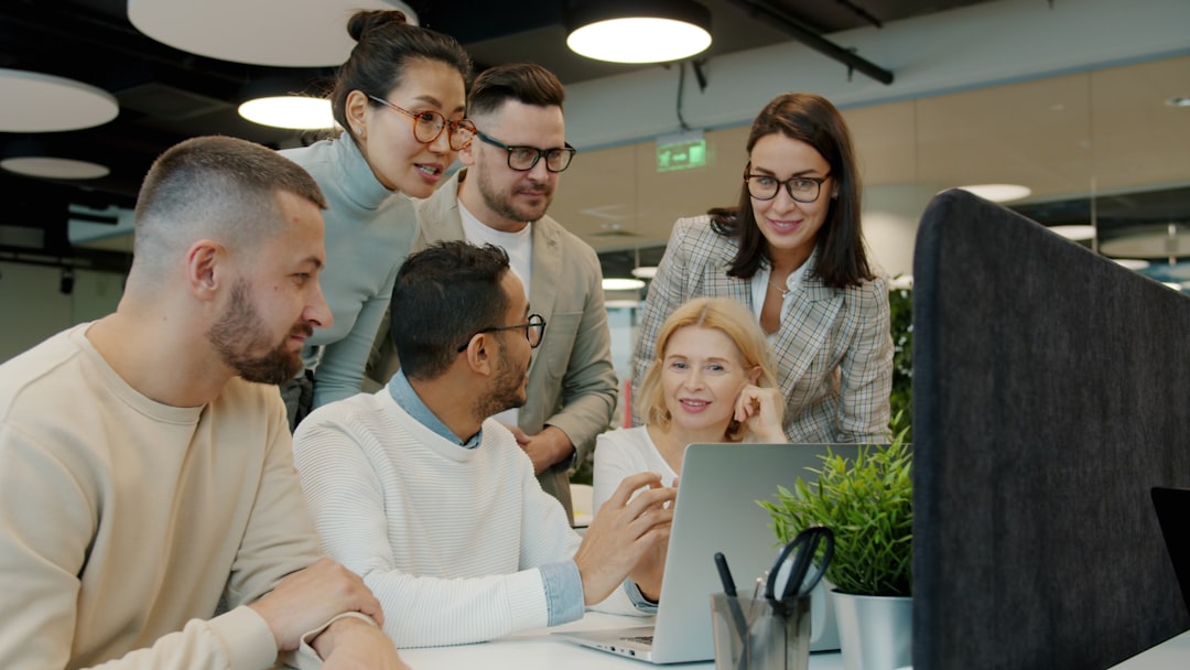 technology global education accessible — team of diverse professionals collaborating during an online training session with meeting software visible