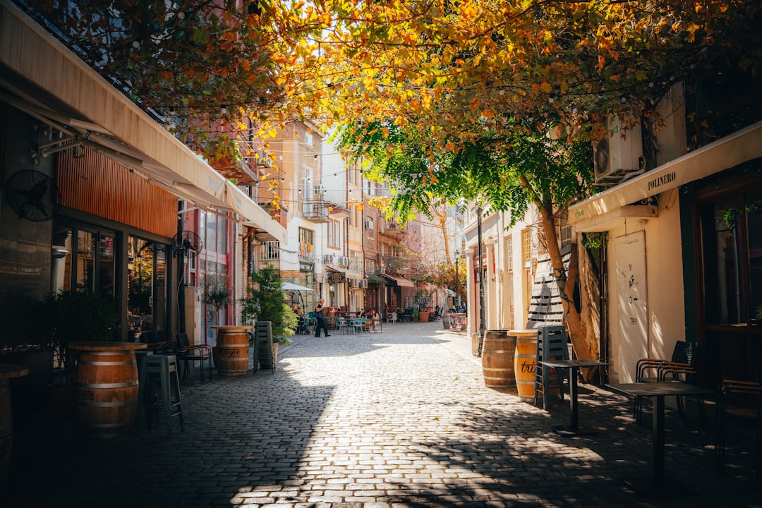 off-season luxury travel popular — travelers strolling through quiet European streets with fallen autumn leaves
