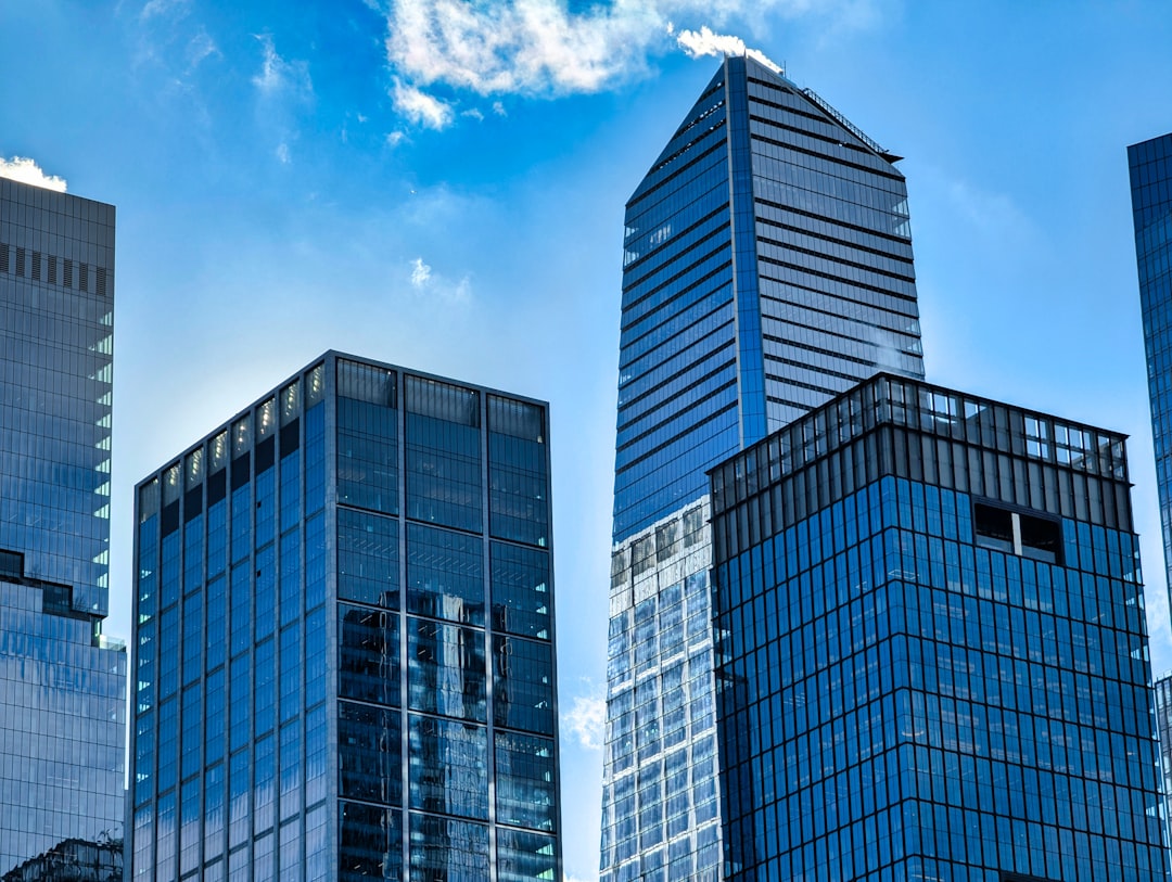 secondary cities new business — glass office building with modern architecture overlooking city skyline