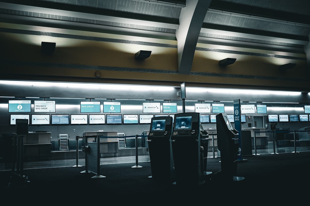 evolution airport experiences digital — control room with real-time monitoring dashboard showing flight operations, passenger flows, and security checkpoint data