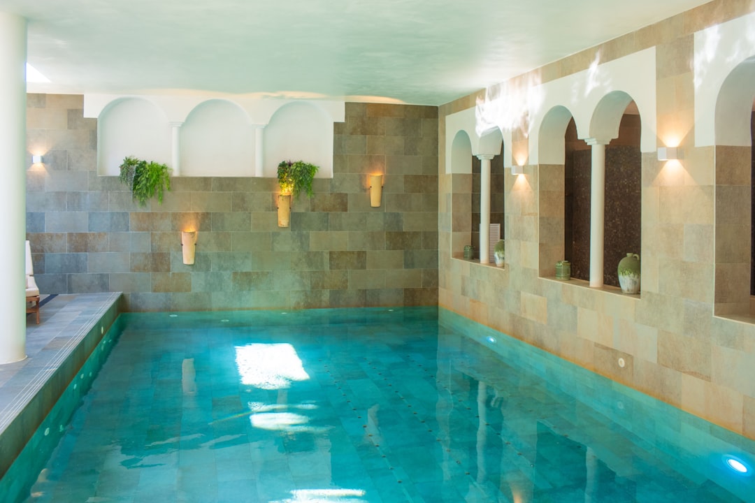 heritage hotels continue attract — luxury spa and wellness suite in a restored historic palazzo with original stone archways and modern furnishings