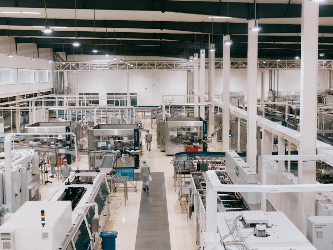 3d printing manufacturing supply — factory floor with industrial printers running in parallel