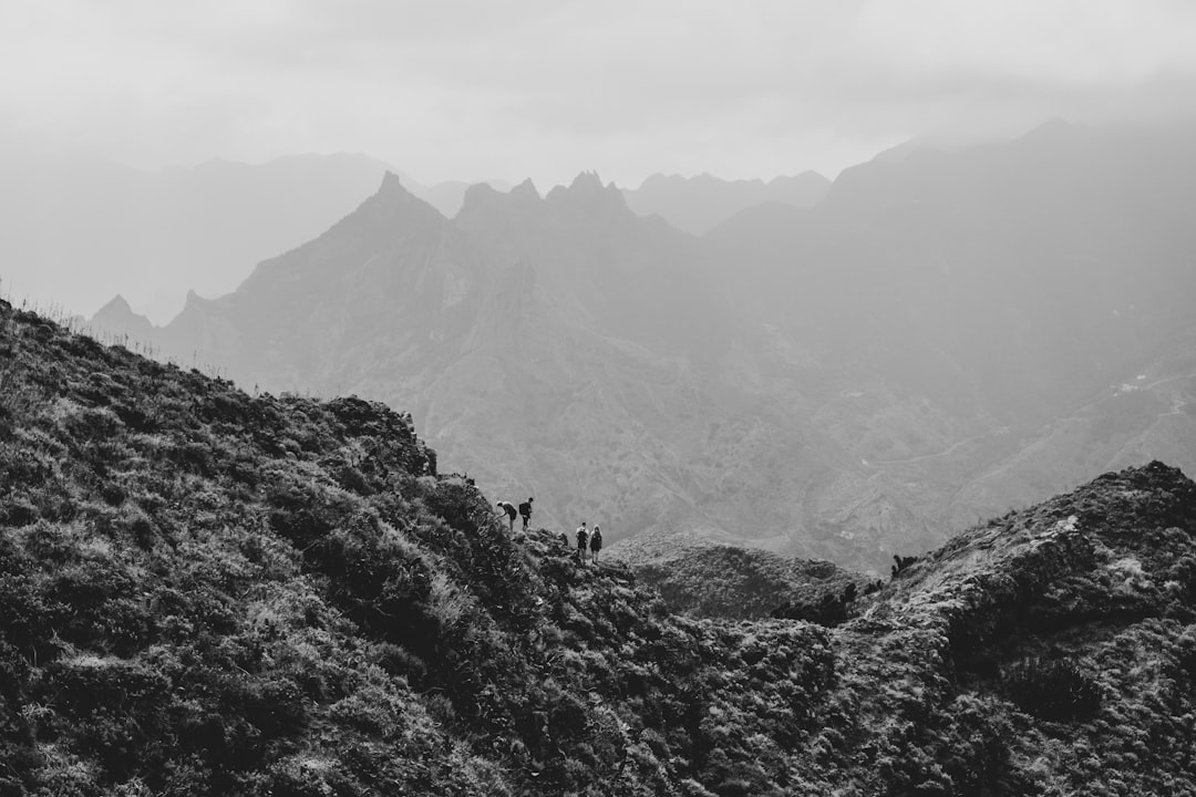 worlds fastest-growing adventure tourism — group of hikers standing on mountain ridge with valley below