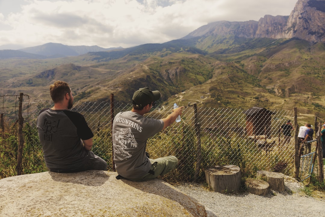 worlds fastest-growing adventure tourism — travelers cooking local cuisine in rustic kitchen overlooking mountain landscape