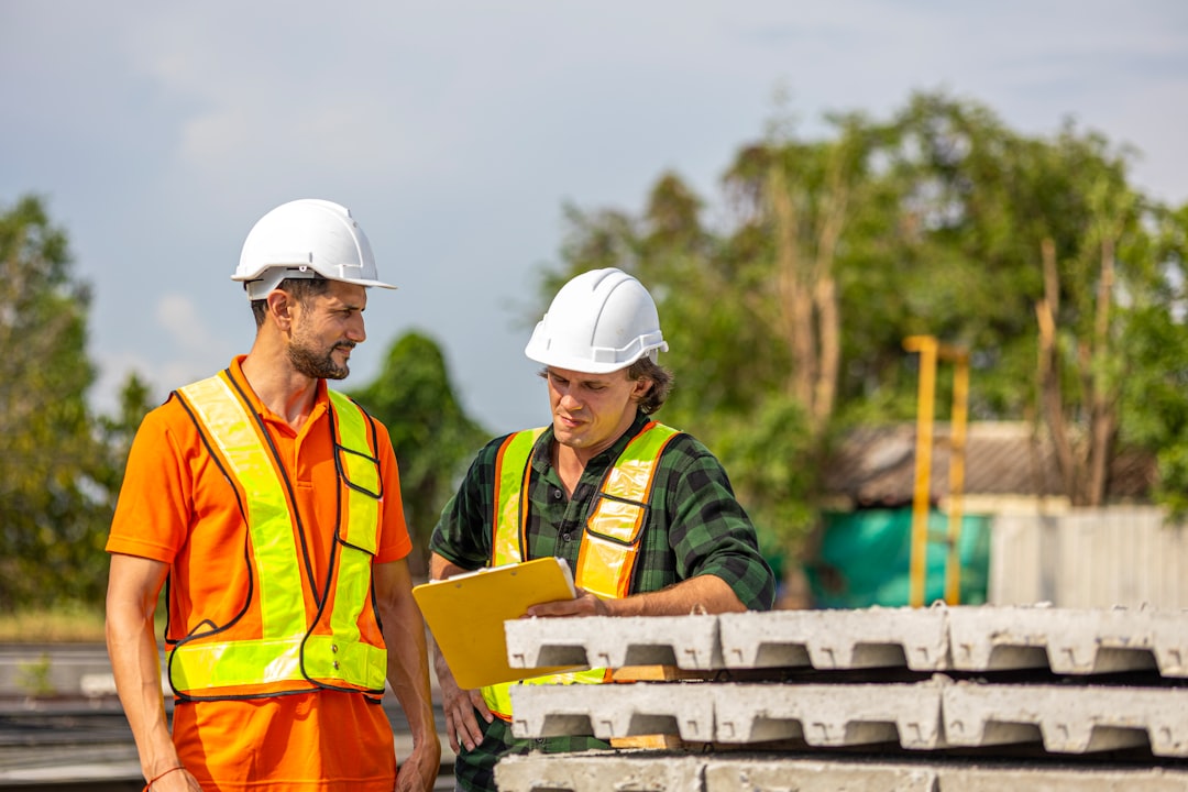 infrastructure investments drive economic — workers inspecting electrical grid infrastructure with clipboard