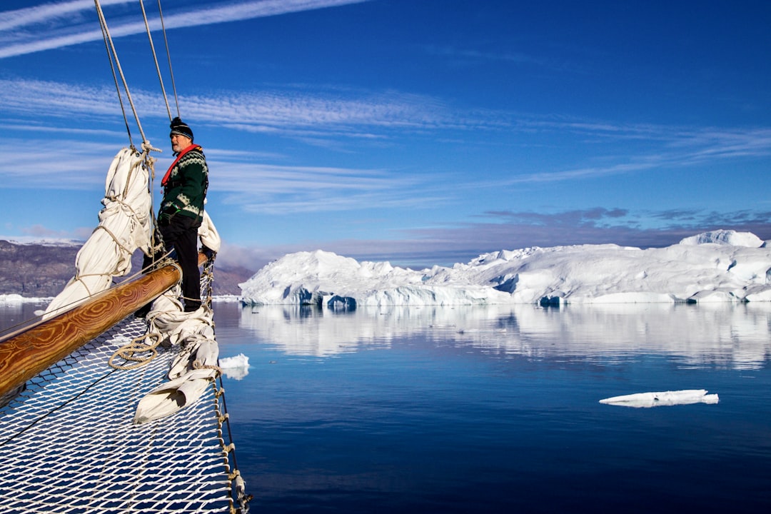 arctic tourism global attention — visitors boarding an expedition cruise in Greenland waters