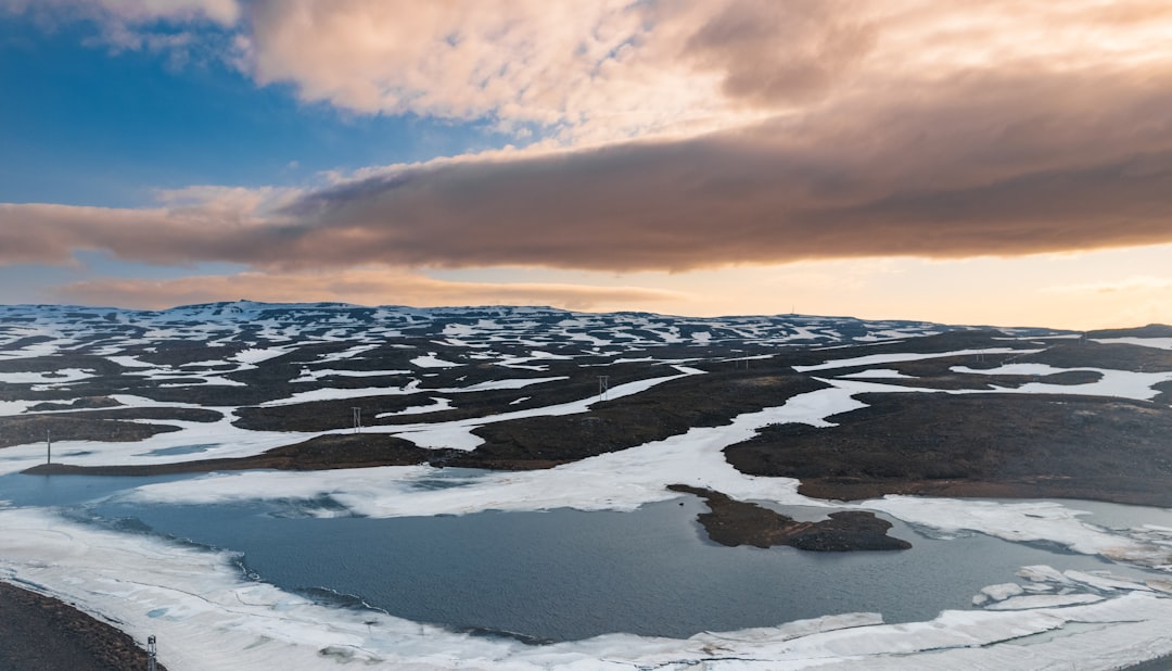 arctic tourism global attention — overhead view of a settlement surrounded by tundra and water
