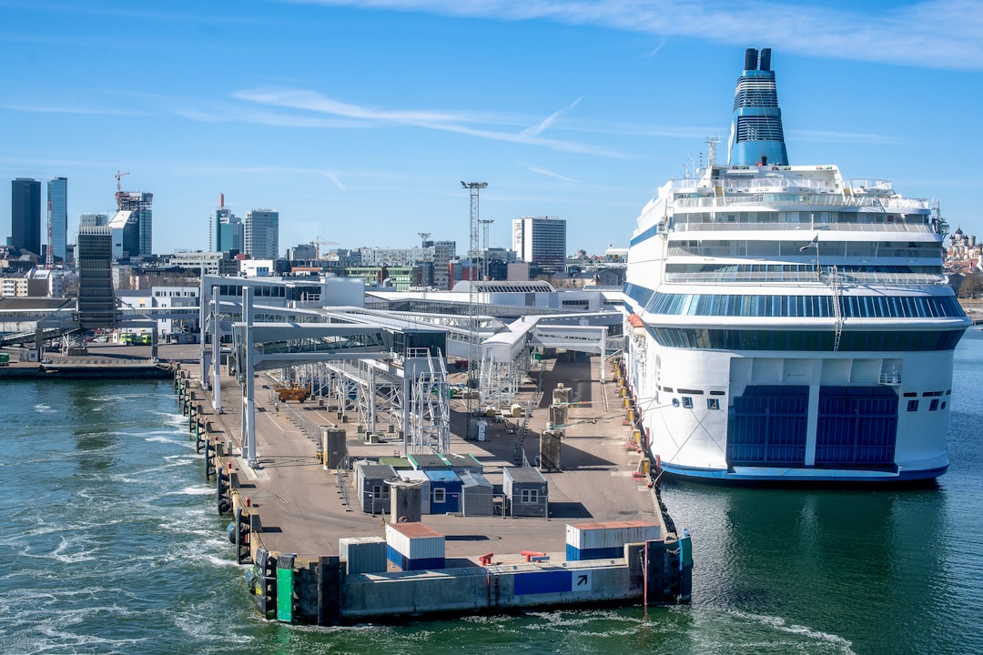 evolution cruise travel modern — port city skyline with cruise ships docked at modern terminal with green energy infrastructure