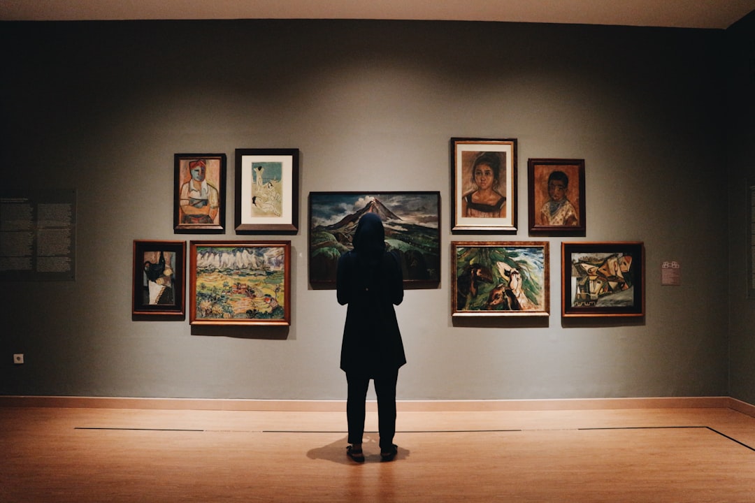 rise fractional ownership luxury — investor examining artwork in a private gallery