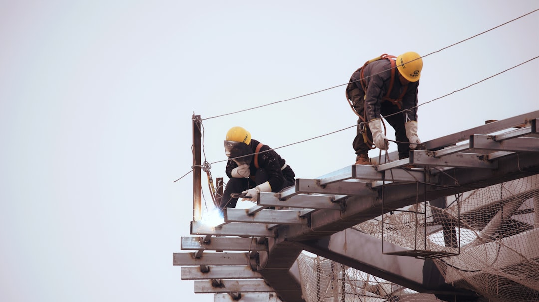 future sustainable infrastructure investments — workers installing electrical grid infrastructure with digital overlay