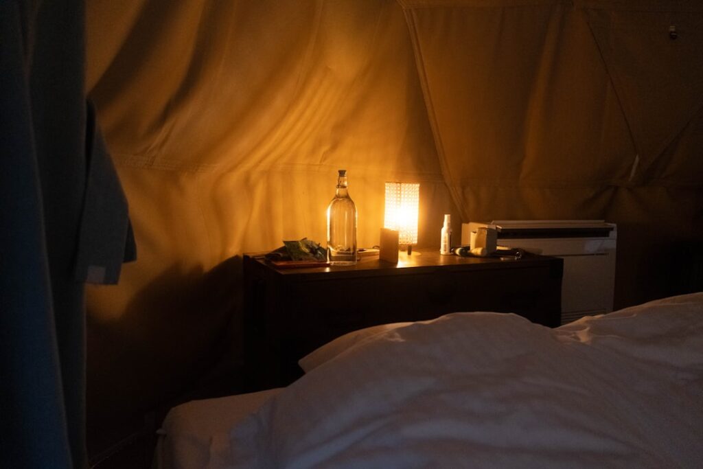 rise luxury camping glamping — Luxury tent interior candlelit evening
