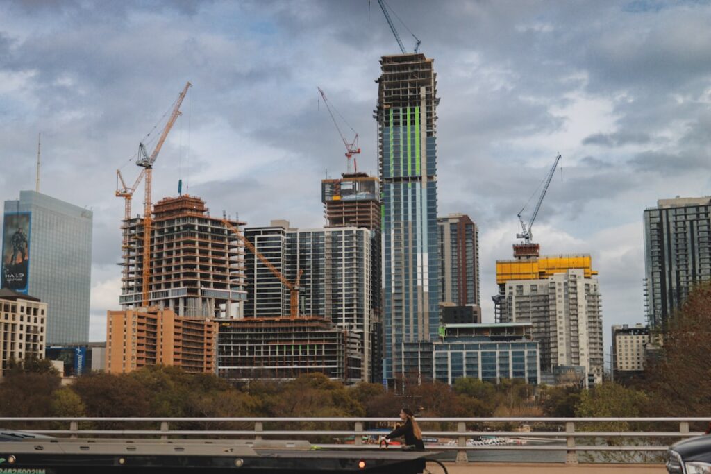 infrastructure funds long-term investors — construction site cranes skyline view