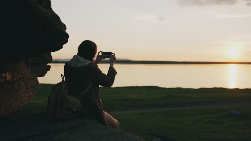 future experiential travel digital — traveler smartphone mountain landscape view