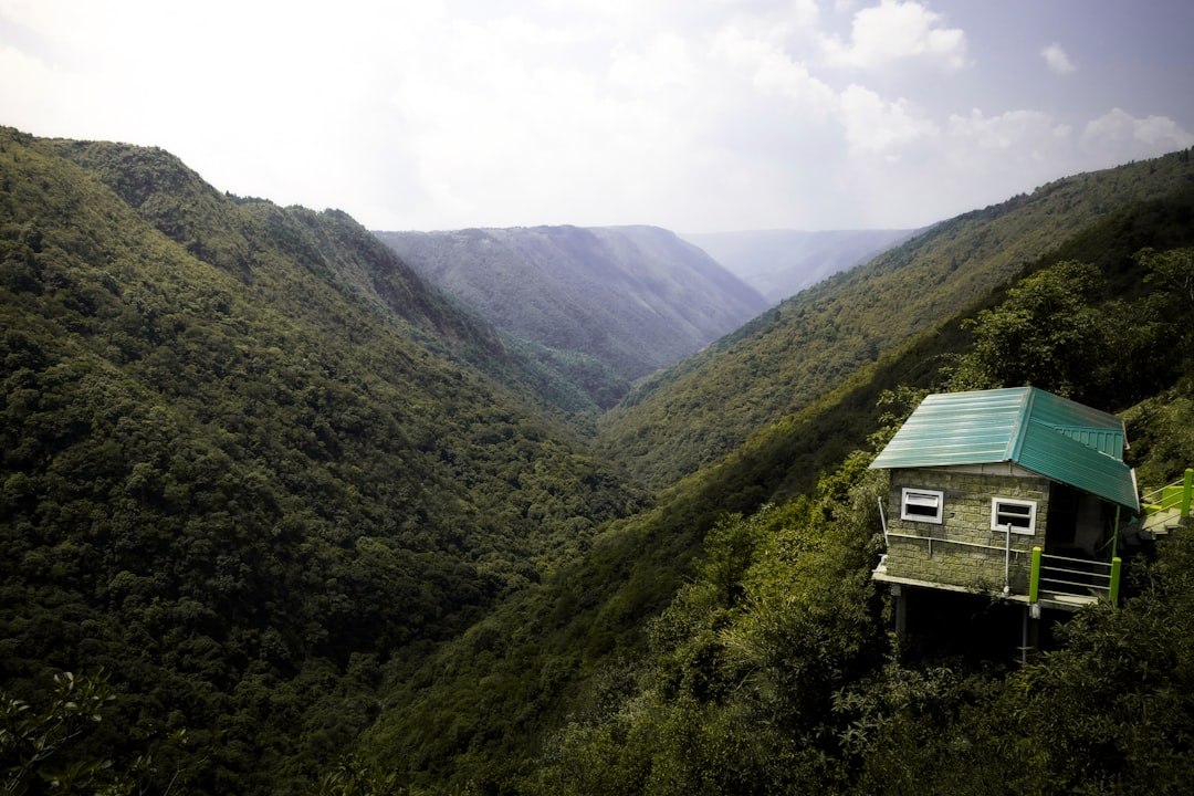 rise luxury camping glamping — luxury safari tent with deck overlooking mountain valley at sunset