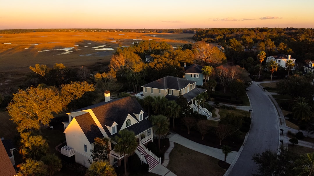 drone technology agriculture infrastructure — emergency response drone equipped with thermal imaging hovering above residential neighborhood at dusk