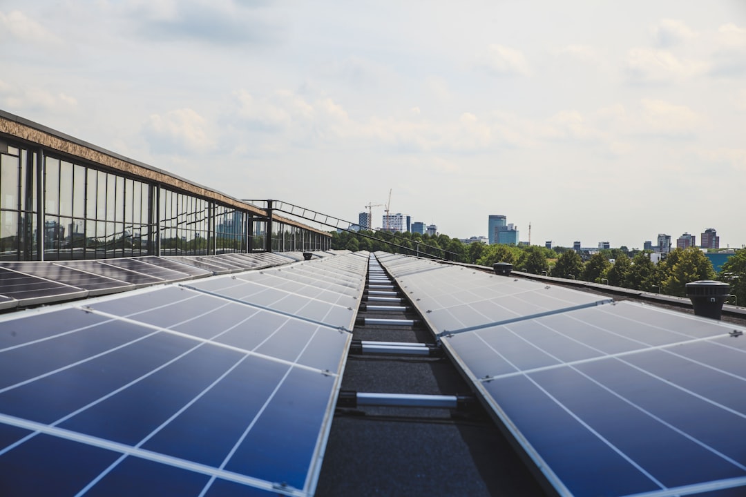 global race build climate-resilient — city skyline with green roofs and solar panels during sunset
