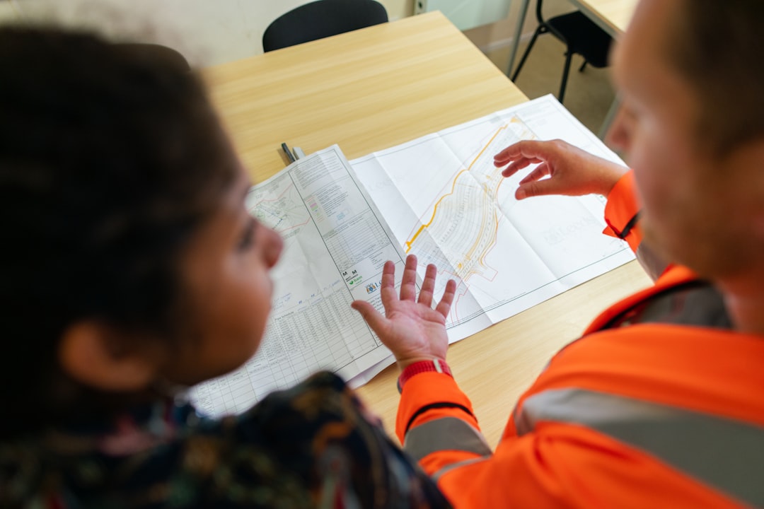 global race build climate-resilient — municipal planning meeting with infrastructure maps and climate risk assessment charts