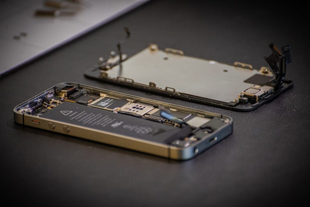 repairable electronics consumer technology — technician repairing smartphone circuit board