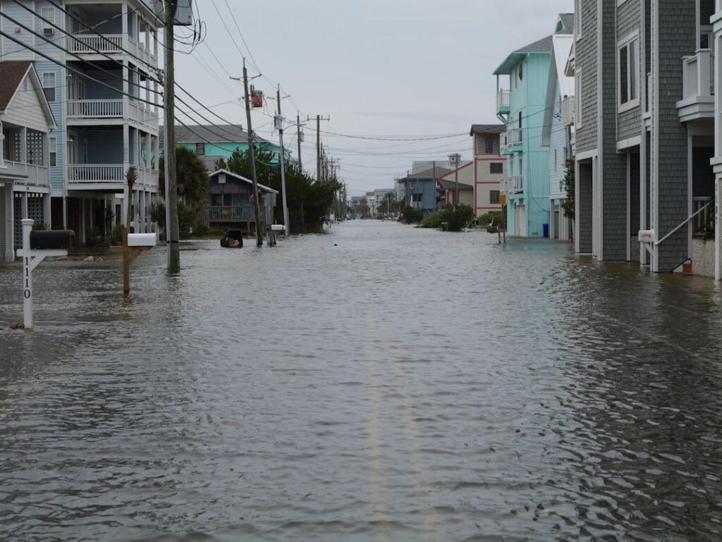climate risk global real — flooded neighborhood houses water damage