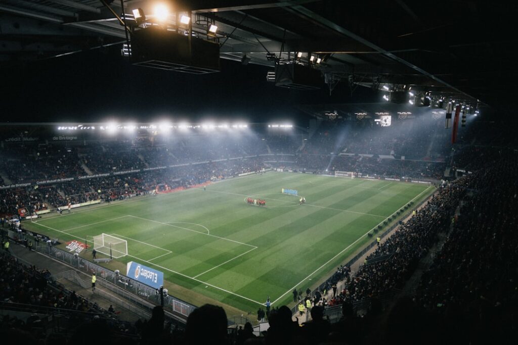 major sporting events transform — crowded stadium night lights cityscape