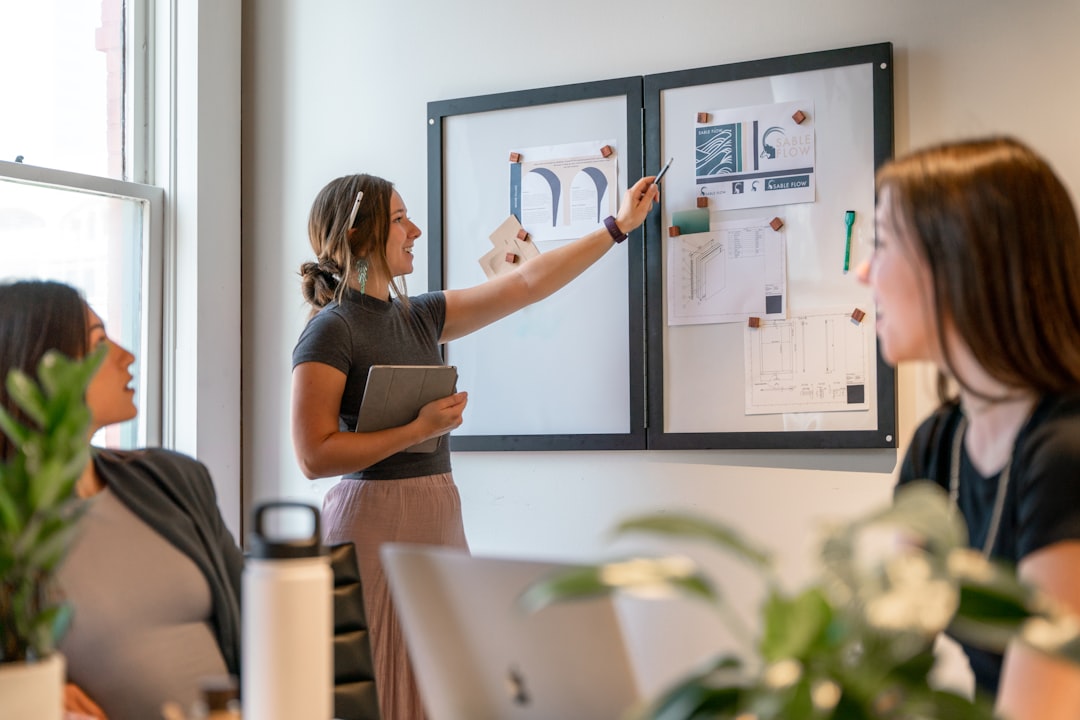 rise women-led businesses emerging — group of women in business meeting with charts on table