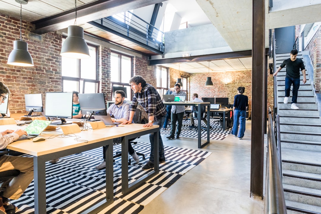 global companies traditional five-day workweek model — employees collaborating on a project in a modern office space