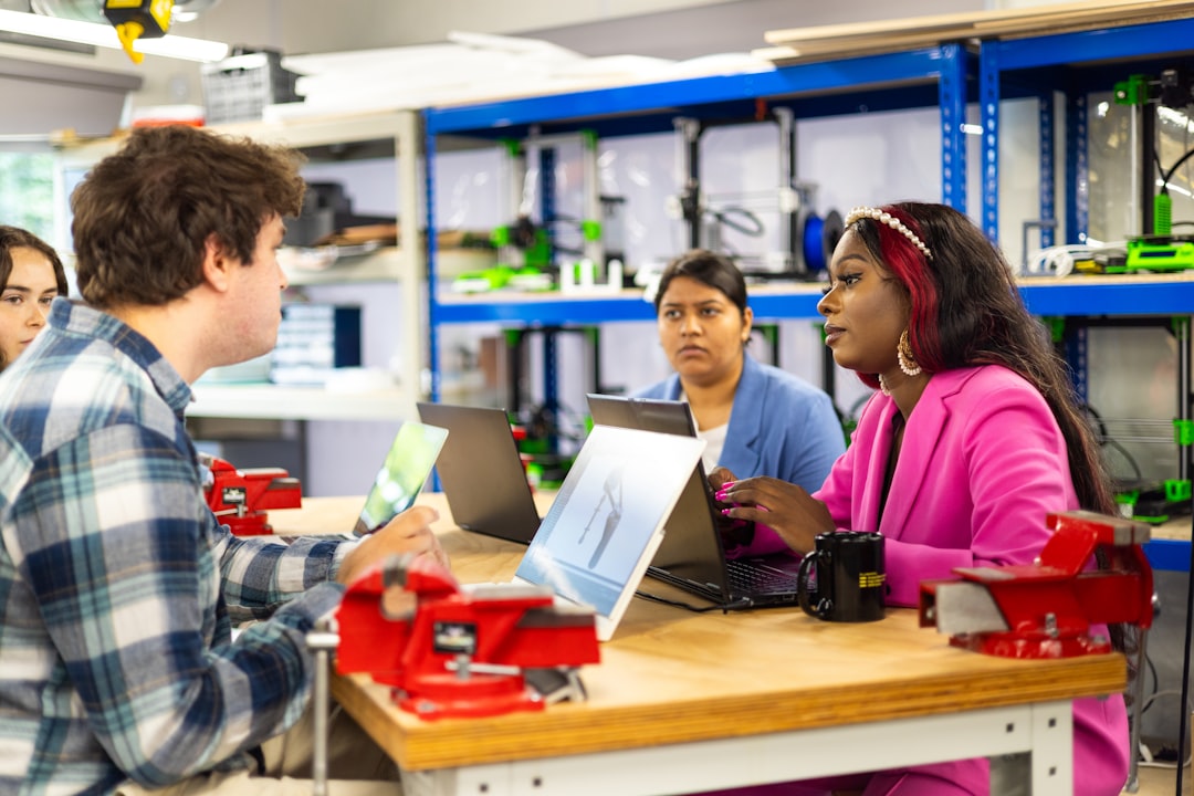 universities stronger partnerships industry — student team working on sustainable tech prototype in lab setting