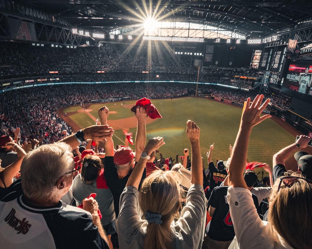 major sporting events transform — crowd of diverse spectators in a packed stadium wearing team colors and waving flags