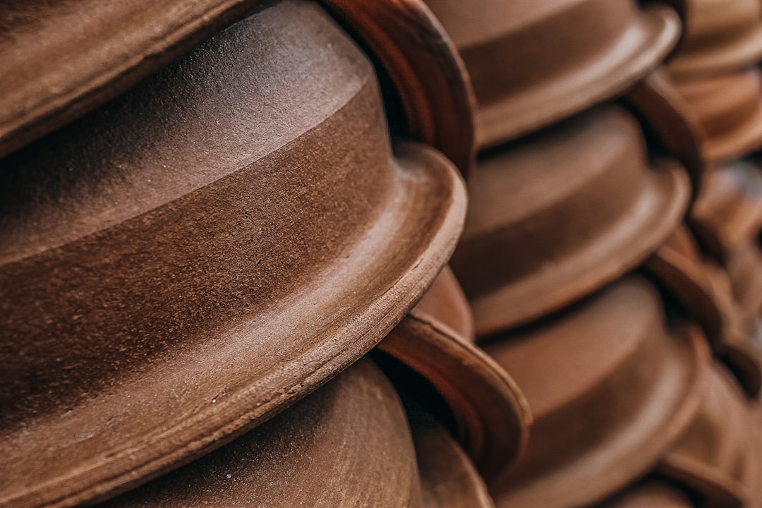 sustainable packaging beyond plastic — a warehouse shelf displaying stacked biodegradable containers in earth tones