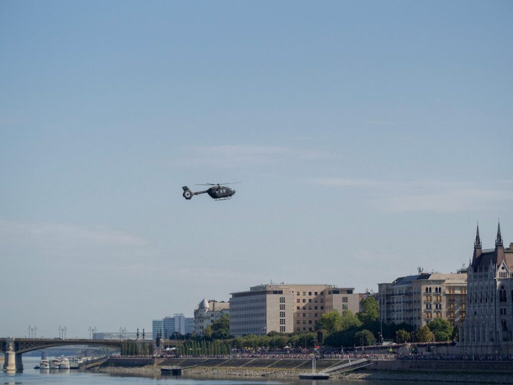 evolution urban air mobility — futuristic aircraft hovering above cityscape