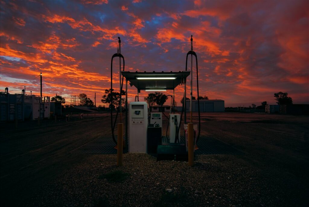 vehicle-to-grid technology change energy — electric car charging station sunset