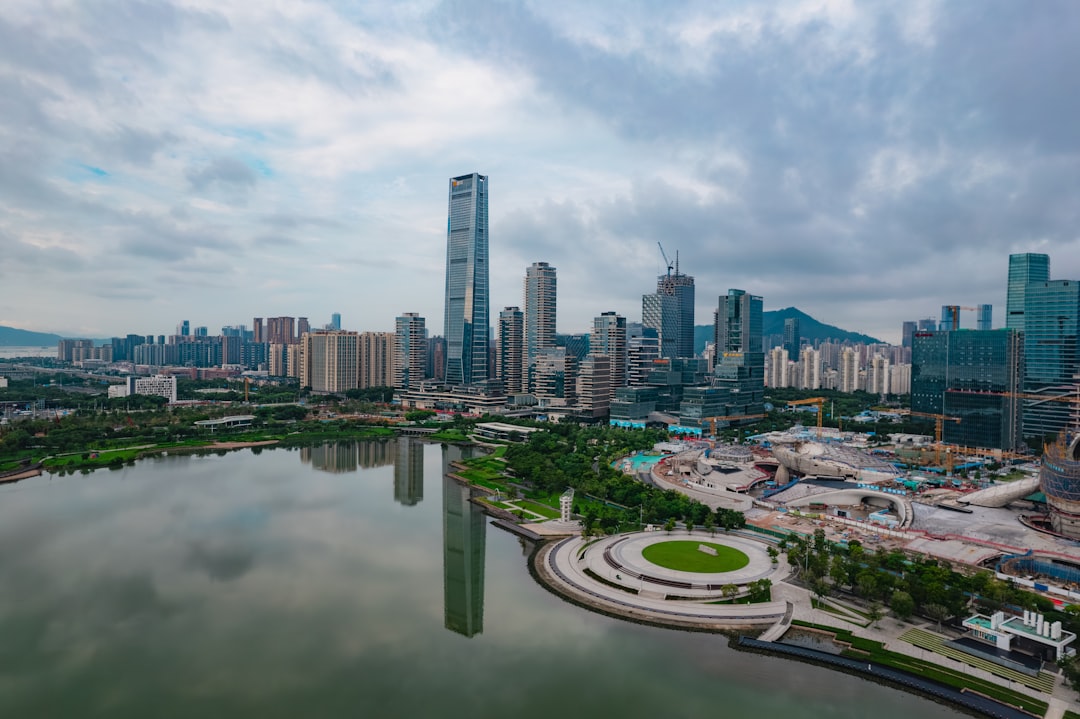 urban regeneration projects global — aerial view of completed waterfront park with mixed development and pedestrian promenade