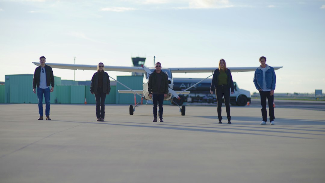 future hydrogen-powered aviation — test pilot standing beside hydrogen aircraft at airport runway