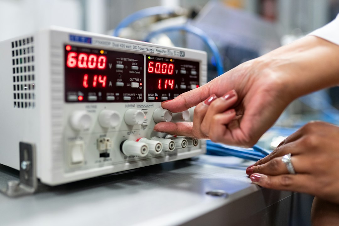 electric aircraft investment aviation — technician testing advanced battery cell in laboratory equipment
