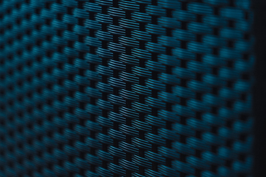 lightweight materials next-generation automobiles — close-up of composite automotive body panel showing carbon fiber weave texture