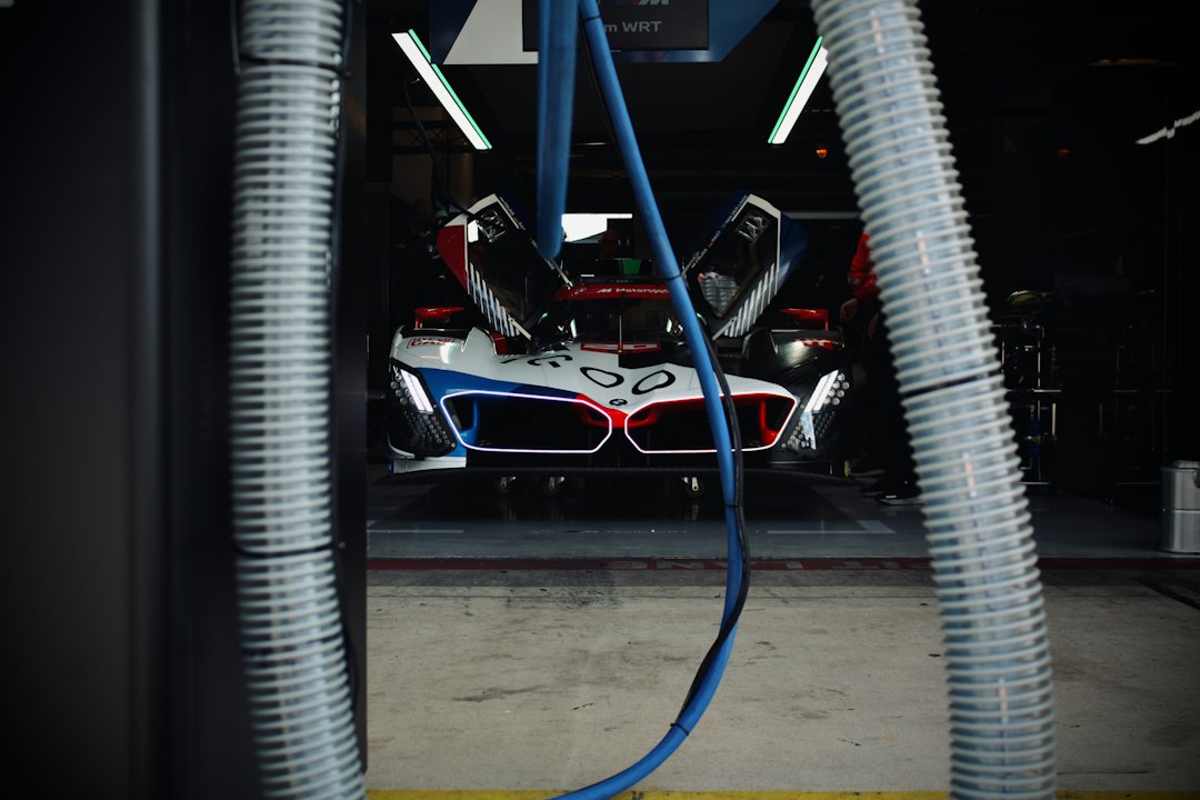 future automotive manufacturing era — BMW factory floor with robotic arms welding vehicle chassis in synchronized motion